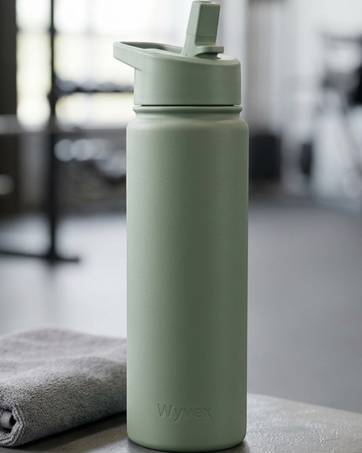 Wyvex Slim Vacuum-Insulated Sports Water Bottle 24 oz Sage Flip-Straw Lid - Lifestyle view